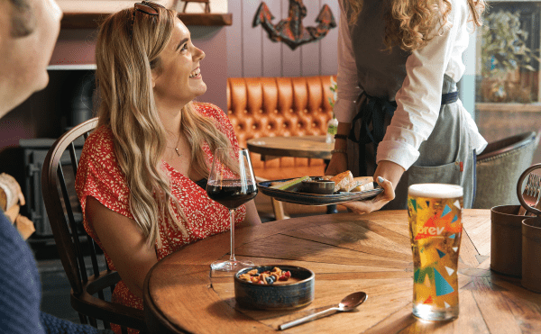 Woman receiving meal in pub