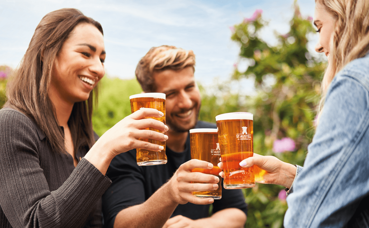 Three friends raising pint 